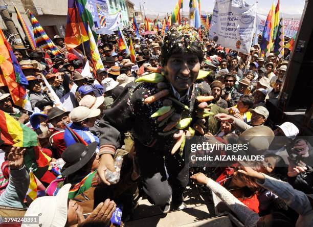 Bolivian President Evo Morales is greeted upon his arrival in Caracollo, some 200 km from La Paz, on October 13, 2008 before the start of a...