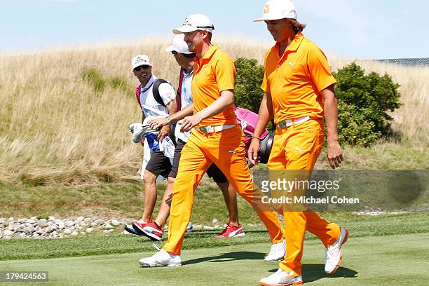 Jonas Blixt of Sweden and Rickie Fowler walk off the first tee box during the fourth round of The Barclays held at Liberty National Golf Club on...