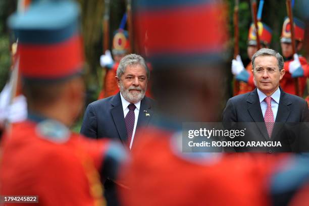 Brazil's President Luiz Inacio Lula da Silva is welcomed with military honours by his Colombian counterpart Alvaro Uribe at the presidential ranch...
