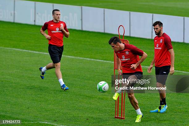 Welsh international and Real Madrid new signing Gareth Bale controls the ball as Joe Ledley looks on during a training session at the Vale Resort...