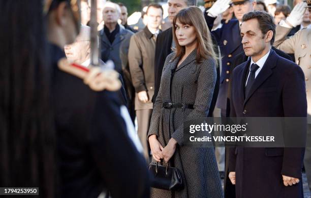 France's President Nicolas Sarkozy and his wife Carla Bruni-Sarkozy take part in the Armistice Day wreath-laying ceremony at the statue of former...