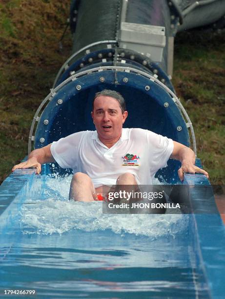 Colombian President Alvaro Uribe gestures while enjoying a water slide in a water park in Manizales, department of Caldas, Colombia, on May 02, 2008....
