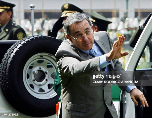 Colombian President Alvaro Uribe waves has he arrives to take part in a police ceremony in Bogota 07 December 2007. Uribe announced the creation of a...