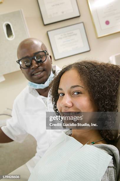 dentist and his teenage patient - surgical loupes stock pictures, royalty-free photos & images