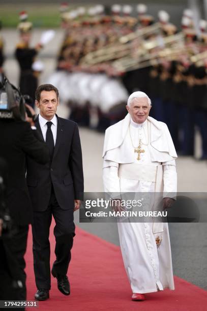 Pope Benedict XVI is accompanied by French President Nicolas Sarkozy upon arrival at Orly airport, south of Paris, on September 12, 2008 for his...