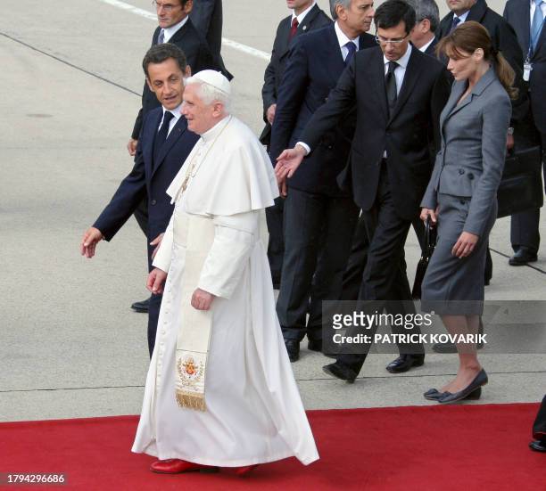 French President Nicolas Sarkozy , his wife Carla Bruni-Sarkozy and Pope Benedict XVI leave the Orly airport, south of Paris, on September 12, 2008...