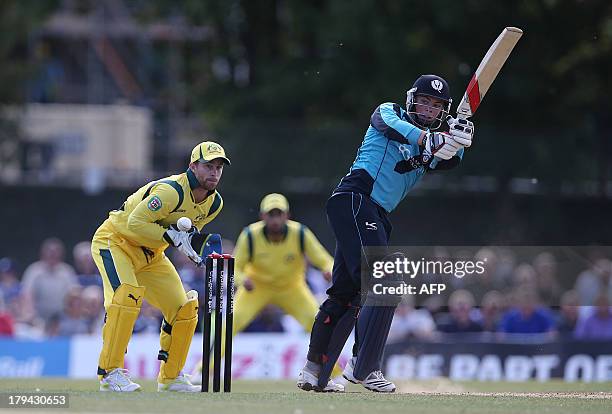 Australia wicketkeeper Matthew Wade looks on as Scotland's Calum McLeod plays a shot during the One Day International cricket match between Scotland...