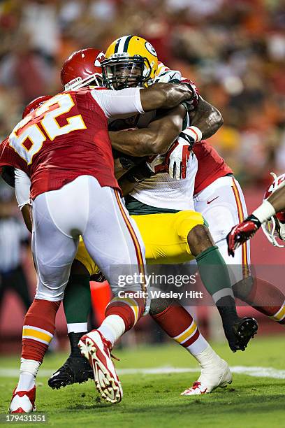 Johnathan Franklin of the Green Bay Packers is tackled by Josh Martin and Rokevious Watkins of the Kansas City Chiefs during the last preseason game...