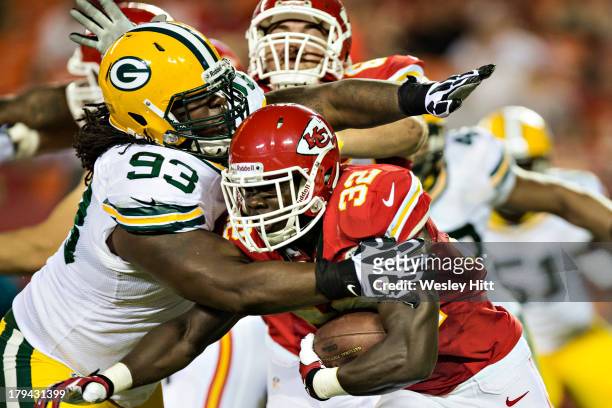 Cyrus Gray of the Kansas City Chiefs is tackled by Josh Boyd of the Green Bay Packers during the last preseason game at Arrowhead Stadium on August...