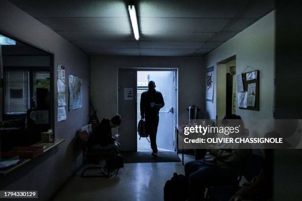 Man arrives for a food distribution at a facility of French charity "Les Restos Du Coeur" on November 21, 2023 in Grenoble, during the launch of its...