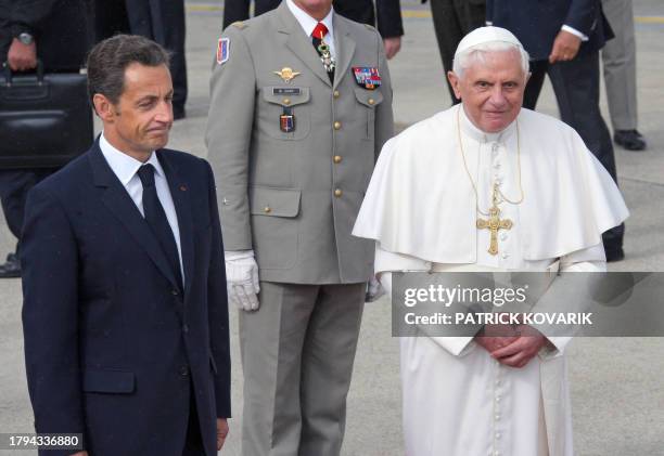 French President Nicolas Sarkozy welcomes Pope Benedict XVI upon his arrival at Orly airport, south of Paris, on September 12, 2008 for his first...