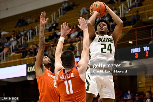 Efrem Johnson of the UAB Blazers shoots over Dillon Hunter and Joseph Girard III of the Clemson Tigers in the second half at Harrah's Cherokee Center...