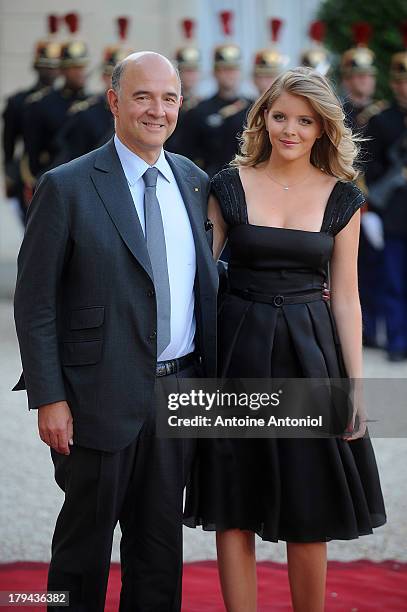 French Finance Minister Pierre Moscovici and his companion Marie-Charline Pacquot arrive at the Elysee Palace for a state dinner on September 3, 2013...