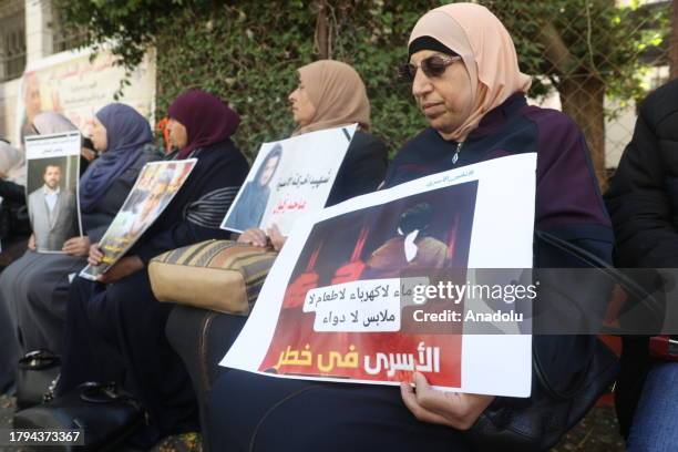 Palestinians, holding banners and photos of their relatives, gather to stage a demonstration on demanding release of the Palestinian prisoners in...