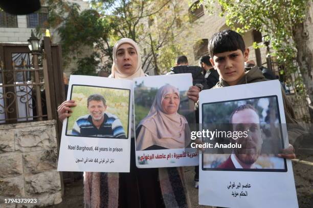 Palestinians, holding banners and photos of their relatives, gather to stage a demonstration on demanding release of the Palestinian prisoners in...