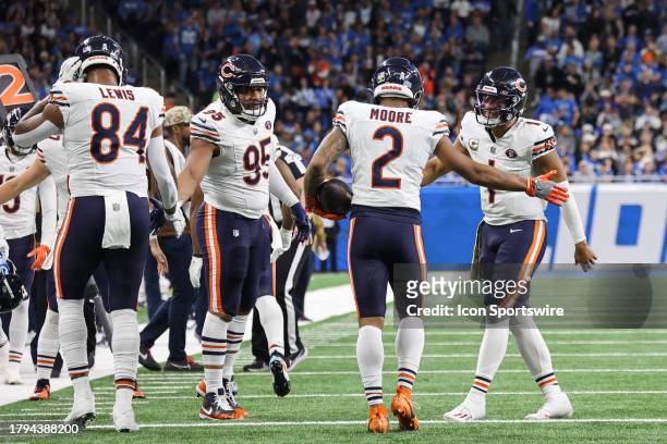 Chicago Bears quarterback Justin Fields congratulates Chicago Bears wide receiver DJ Moore for catching a pass in the end zone for a touchdown while...