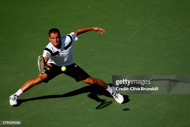 Mikhail Youzhny of Russia plays a forehand during his men's singles fourth round match against Lleyton Hewitt of Australia on Day Nine of the 2013 US...