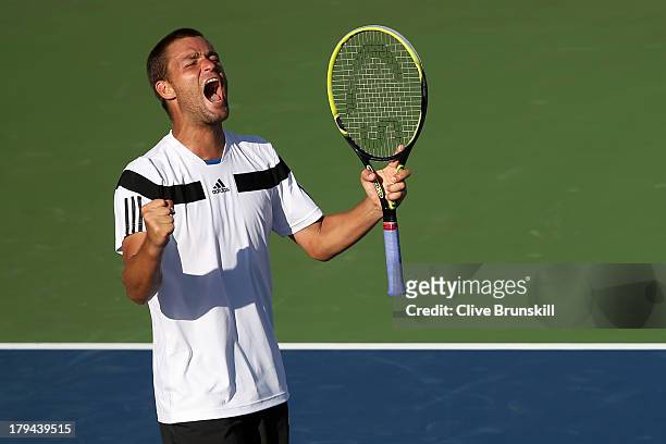 Mikhail Youzhny of Russia celebrates match point during his men's singles fourth round match against Lleyton Hewitt of Australia on Day Nine of the...