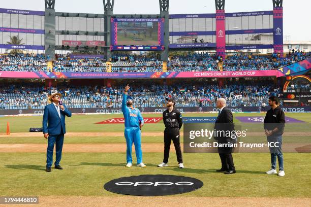 Rohit Sharma of India and Kane Williamson of New Zealand take part in the coin toss alongside Match Referee Andy Pycroft during the ICC Men's Cricket...