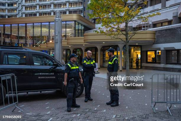 Police officers stand guard outside the Statenpassage building ahead of a televised debate between party leaders, the last before tomorrow's general...