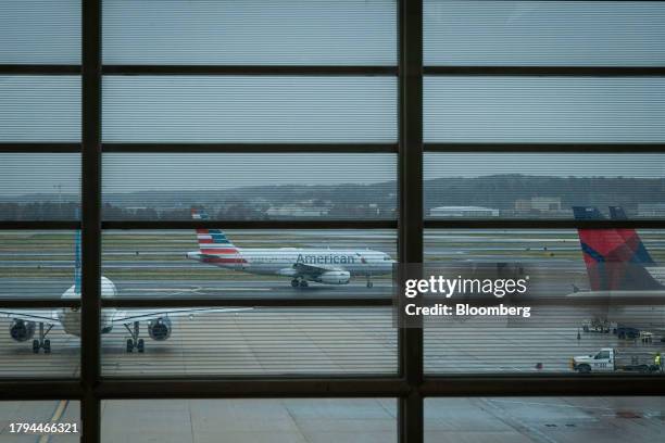 JetBlue, American Airlines and Delta Air Lines airplanes at Ronald Reagan National Airport in Arlington, Virginia, U.S., on Tuesday, Nov. 21, 2023....