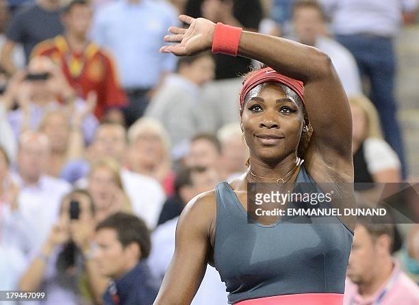 Tennis player Serena Williams celebrates winning against Spain's Carla Suarez Navarro during their 2013 US Open women's singles match at the USTA...
