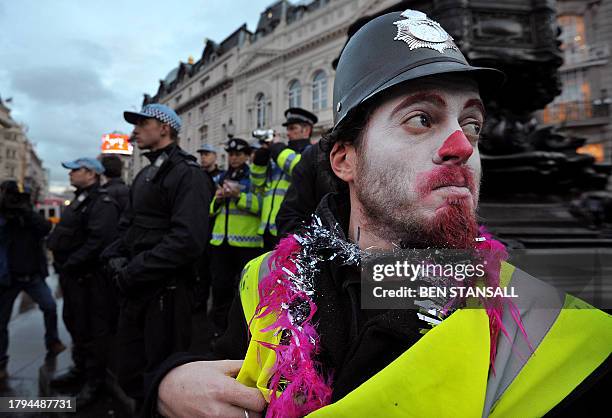 Demonstrator with a painted face and a fake police helmet is pictured during a rally as public service workers strike over pensions in central...