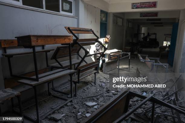 Palestinian boy checks the damages at a UN school in Bureij in the central Gaza Strip, on November 21 amid the ongoing battles between Israel and the...