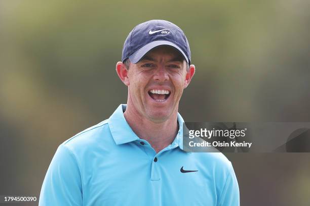 Rory McIlroy of Northern Ireland laughs on the 18th green prior to the DP World Tour Championship on the Earth Course at Jumeirah Golf Estates on...