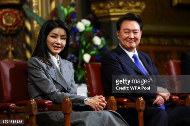 South Korea's President Yoon Suk Yeol sits with his wife Kim Keon Hee, after he addressed MPs in the Royal Gallery during a visit to the Palace of...
