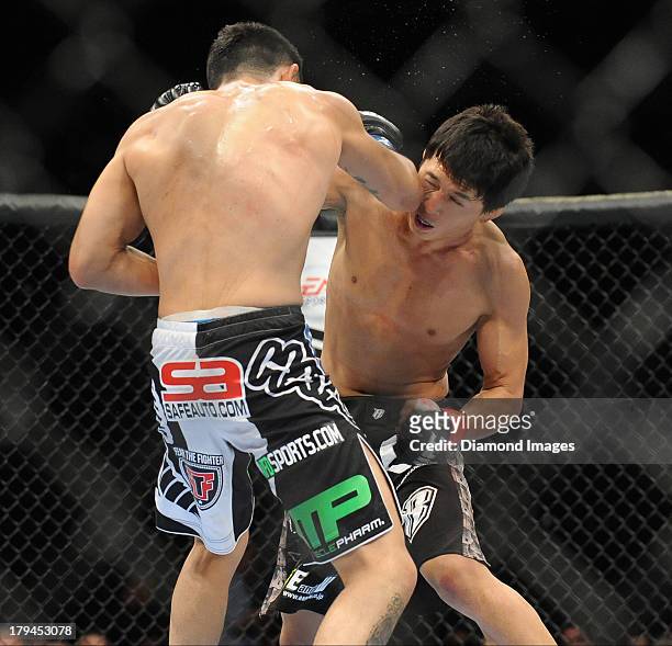 Takeya Mizugaki throws a punch during a bantamweight bout during UFC Fight Night 27 Condit v Kampmann 2 at Bankers Life Field House in Indianapolis,...