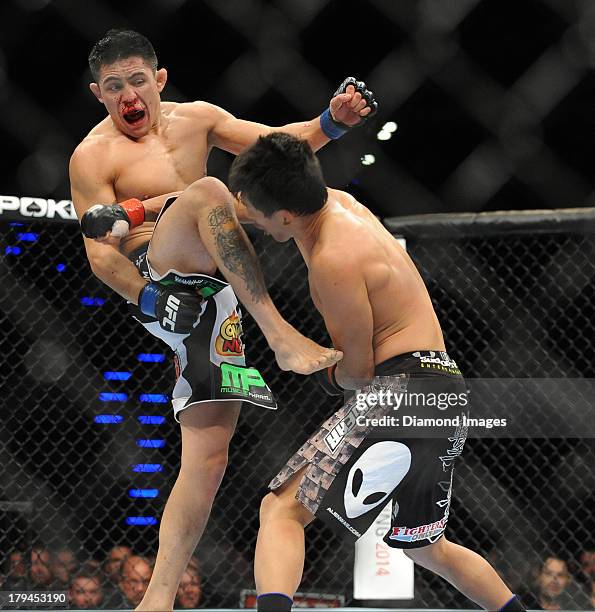 Erik Perez connects with a kick to the head of Takeya Mizugaki during a bantamweight bout during UFC Fight Night 27 Condit v Kampmann 2 at Bankers...