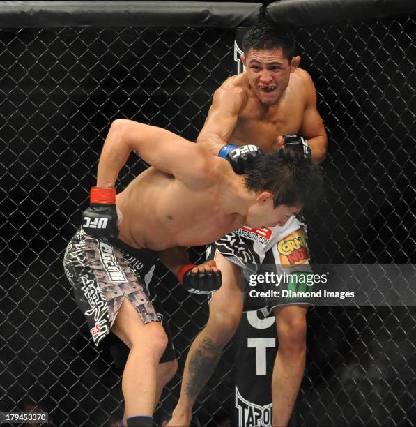 Erik Perez connects with a punch during a bantamweight bout during UFC Fight Night 27 Condit v Kampmann 2 at Bankers Life Field House in...