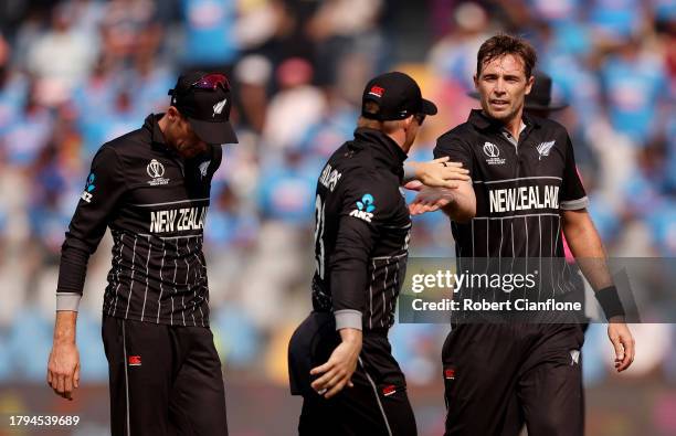 Tim Southee of New Zealand celebrates with teammates after dismissing Rohit Sharma of India during the ICC Men's Cricket World Cup India 2023 Semi...