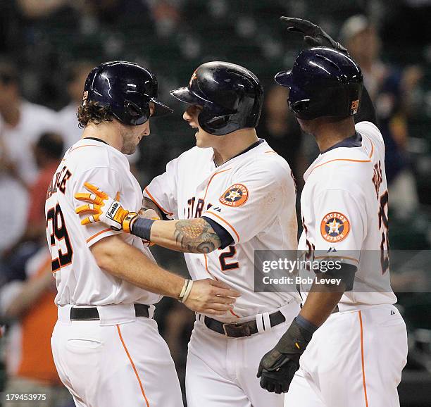 Brandon Barnes of the Houston Astros celebrates with L.J. Hoes and Brett Wallace after hitting a three-run home run in the ninth inning to tie the...