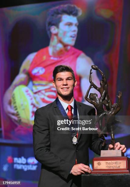 Jaeger O'Meara of the Gold Coast Suns poses with the trophy after winning the 2013 Ron Evans Medal NAB Rising Star Award as the best young player in...