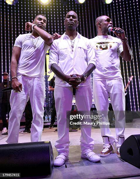 Singers Ginuwine, Tyrese and Tank of R&B Supergroup TGT perform at 5 Towers Outdoor Concert Arena on September 3, 2013 in Universal City, California.