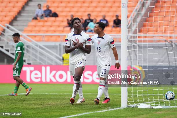 Keyrol Figueroa of USA celebrates with Peyton Miller after scoring the team's first goal during the Group E match between USA and Burkina Faso during...