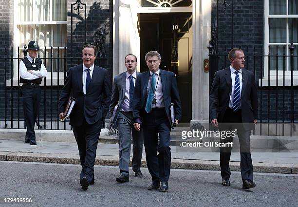 British Prime Minster David Cameron leaves Number 10 Downing Street ahead of the weekly Prime Minister's Questions in the House of Commons on...