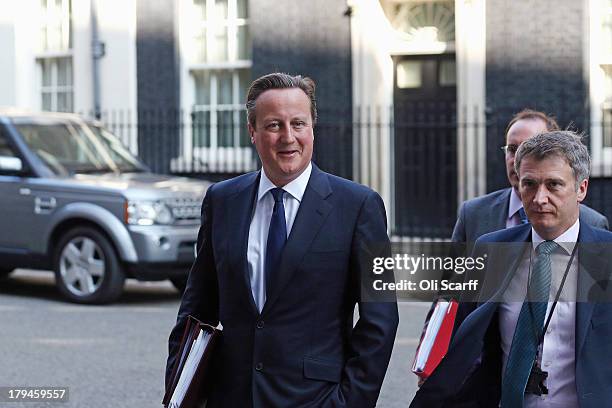 British Prime Minster David Cameron leaves Number 10 Downing Street ahead of the weekly Prime Minister's Questions in the House of Commons on...