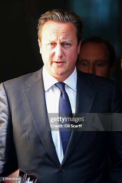 British Prime Minster David Cameron leaves Number 10 Downing Street ahead of the weekly Prime Minister's Questions in the House of Commons on...