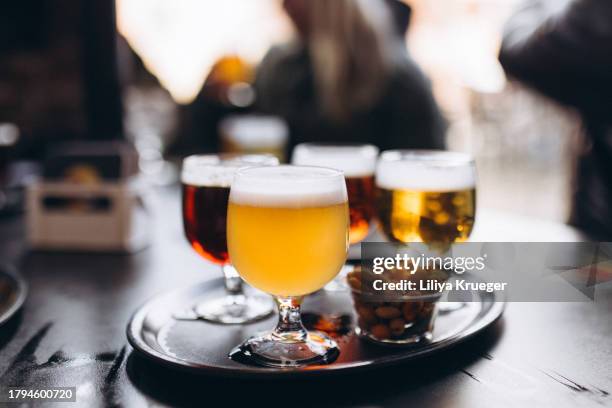 close-up of different types of belgian beer in a pub in bruges. - belgian culture stock pictures, royalty-free photos & images