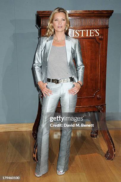 Kate Moss poses at a photocall ahead of the 'Kate Moss: The Collection' auction which sees various artworks of the model, curated by Gert Elfering,...