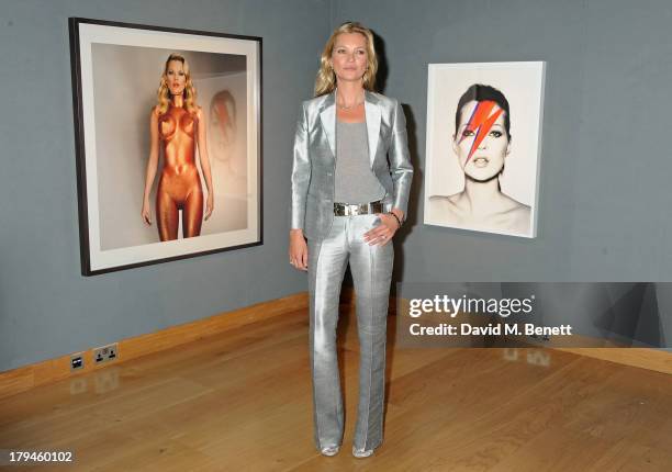 Kate Moss poses at a photocall ahead of the 'Kate Moss: The Collection' auction which sees various artworks of the model, curated by Gert Elfering,...