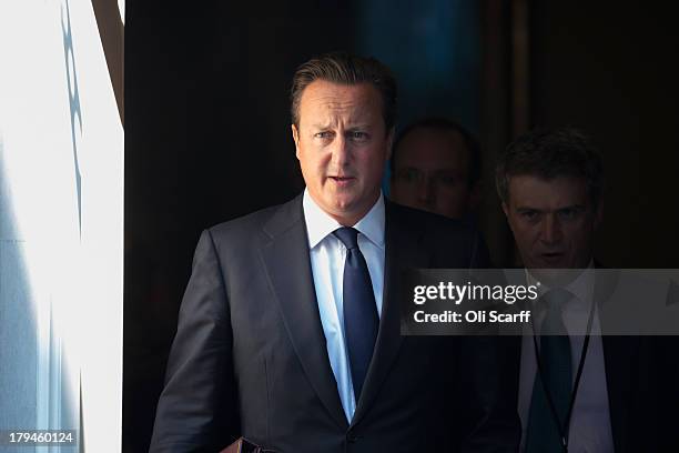 British Prime Minster David Cameron leaves Number 10 Downing Street ahead of the weekly Prime Minister's Questions in the House of Commons on...