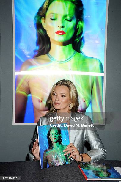 Kate Moss poses at a photocall ahead of the 'Kate Moss: The Collection' auction which sees various artworks of the model, curated by Gert Elfering,...