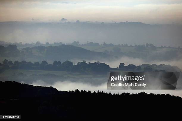 The dawn sun begins to clear the mist and fog lingering in fields close to the city of Wells on September 4, 2013 in Somerset, England. Parts of the...