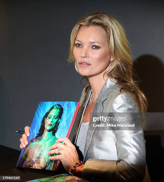 Kate Moss poses at a photocall ahead of the 'Kate Moss: The Collection' auction which sees various artworks of the model curated by Gert Elfering go...