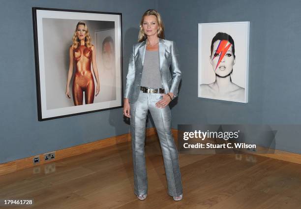 Kate Moss poses at a photocall ahead of the 'Kate Moss: The Collection' auction which sees various artworks of the model curated by Gert Elfering go...