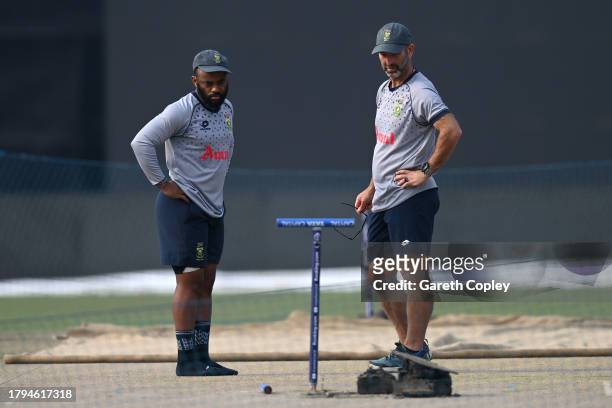 South Africa captain Temba Bavuma looks at the pitch with coach Rob Walter during a nets session at Eden Gardens on November 15, 2023 in Kolkata,...